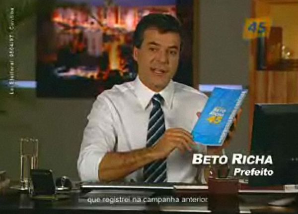 Beto Richa, na tevê, segurando o plano de governo: destaque para suas realizações | Reprodução