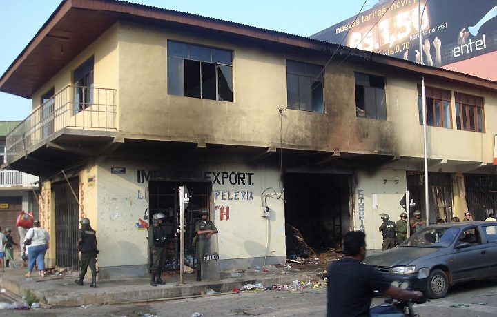 Em Cobija, policiais montam guarda na frente de loja de propriedade de um primo do presidente da Bolívia, Evo Morales. O estabelecimento foi atacado por oposicionistas | Reuters