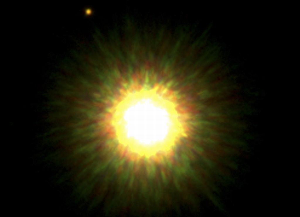 A estrela 1RXSJ160929 com seu provável planeta (pequeno e vermelho, no alto, à esquerda) | Observatório Gemini / Reuters