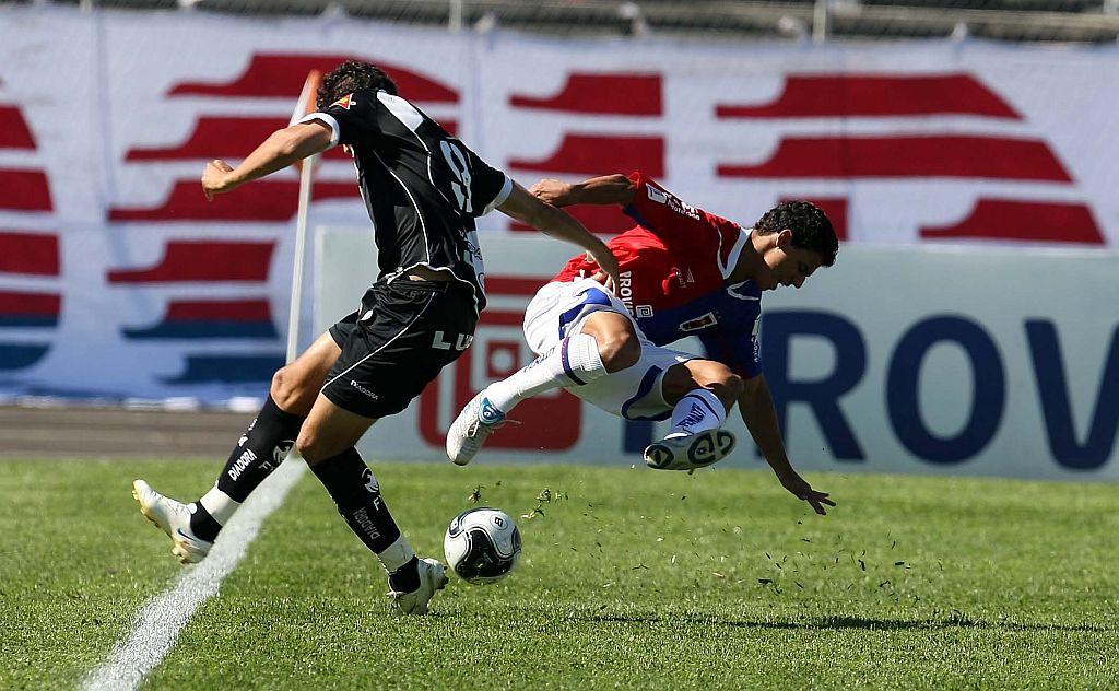 O atacante Neto, da Ponte, chega rasgando no lateral paranista Murilo: torcida pode pagar o bicho pela vitória sobre a Macaca. | Hedeson Alves/ Gazeta do Povo
