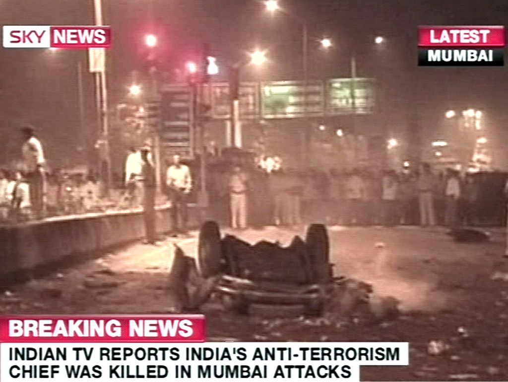 TV indiana via Sky News mostra policiais em torno de um carro destroçado após uma série de explosões em Mumbai | SKY NEWS / AFP Photo