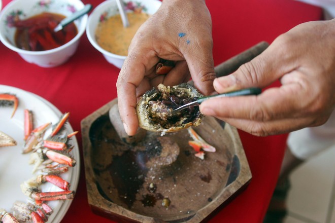 Terminando as patas é hora de preparar um pirão de feijão na carapaça. Tire a parte de cima da carapaça, elimine o líquido que fica acumulado, pois ele é amargo. Misture feijão e farofa na carapaça. Se apreciar, algumas gotas de pimenta são bem vindas | 