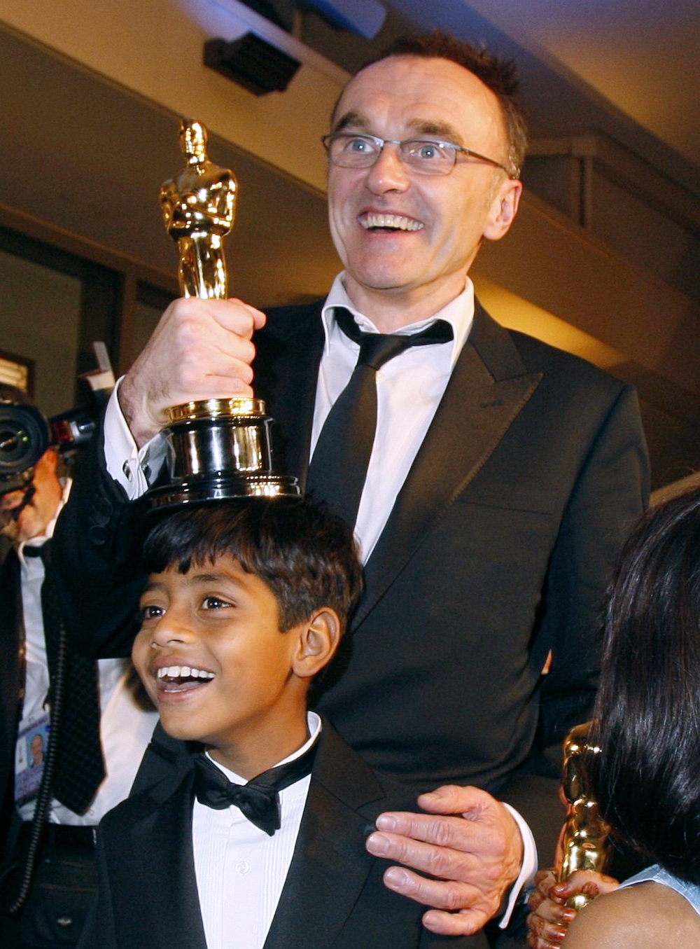 Diretor Danny Boyle comemora estatueta ao lado do ator mirim Azharuddin Mohammed Ismail | Reuters/Lucas Jackson