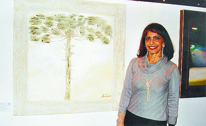 Posando ao lado de sua tela