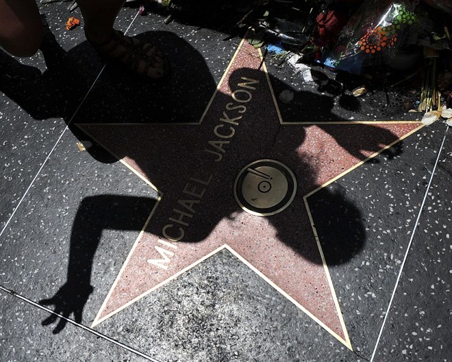 Fã projeta sua sombra sobre a estrela de Michael Jackson na Calçada da Fama, em Hollywood, em Los Angeles | 