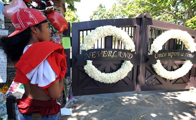 Fã de Michael Jackson aguarda em frente ao portão do rancho Neverland, na Califórnia: indecisão se o velório vai ser público no local |
