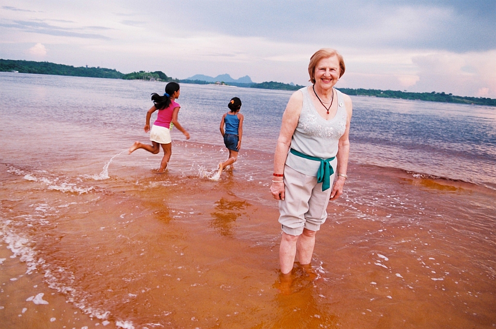 A médica Zilda Arns Neumann posa em praia do Rio Negro, na cidade de São Gabriel da Cachoeira, no Amazonas, tendo ao fundo duas crianças | Fotos Jader da Rocha