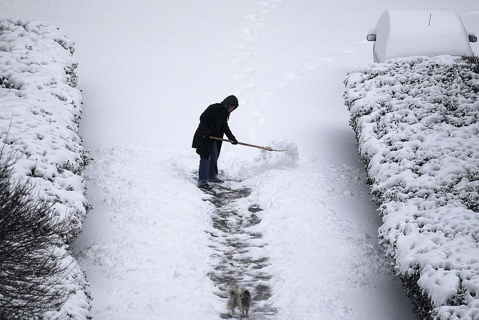 Homem retira neve de rua no norte da China. Frio está prejudicando o fornecimento de energia elétrica | Reuters