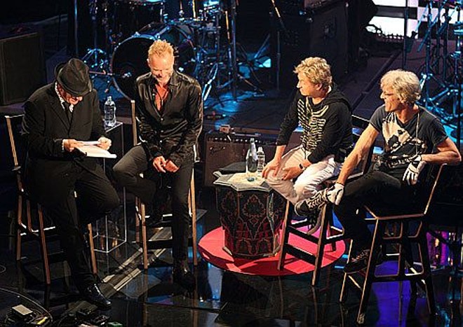 O apresentador, de chapéu, conversa com os integrantes da banda The Police |