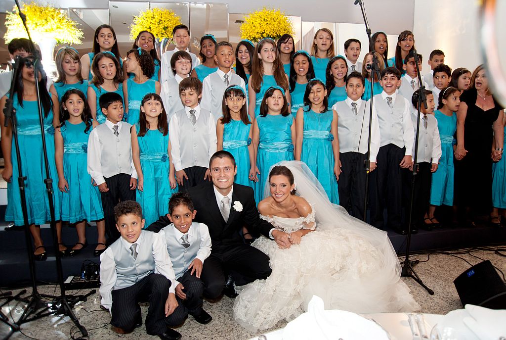 Maria Alice Engel, filha do presidente do HSBC Brasil, Conrado Engel, e o marido, Rafael de Oliveira, fizeram questão de posar junto ao coral infantil do banco, que fez uma bela e especial participação em seu casamento, realizado na última sexta-feira no buffet Nuvem de Coco | Silvestre Laska/Namester Produções