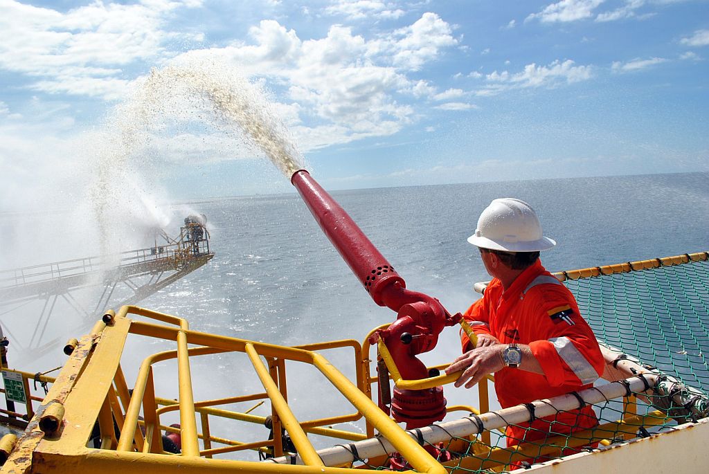 Imagem divulgada pela companhia estatal venezuelana mostra funcionário resfriando local da plataforma que naufragou | Reuters