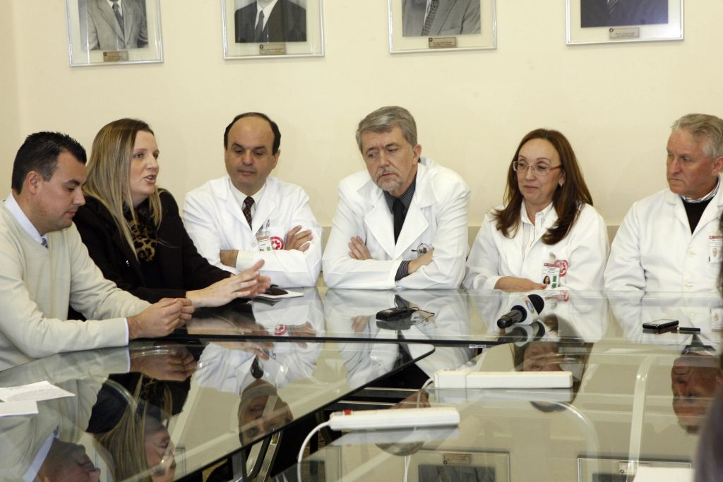 Thiago e Paula, pais de Helena (à esquerda), e a equipe médica responsável pela cirurgia que salvou a criança: bebê precisará de acompanhamento por um ano | Priscila Forone/Gazeta do Povo