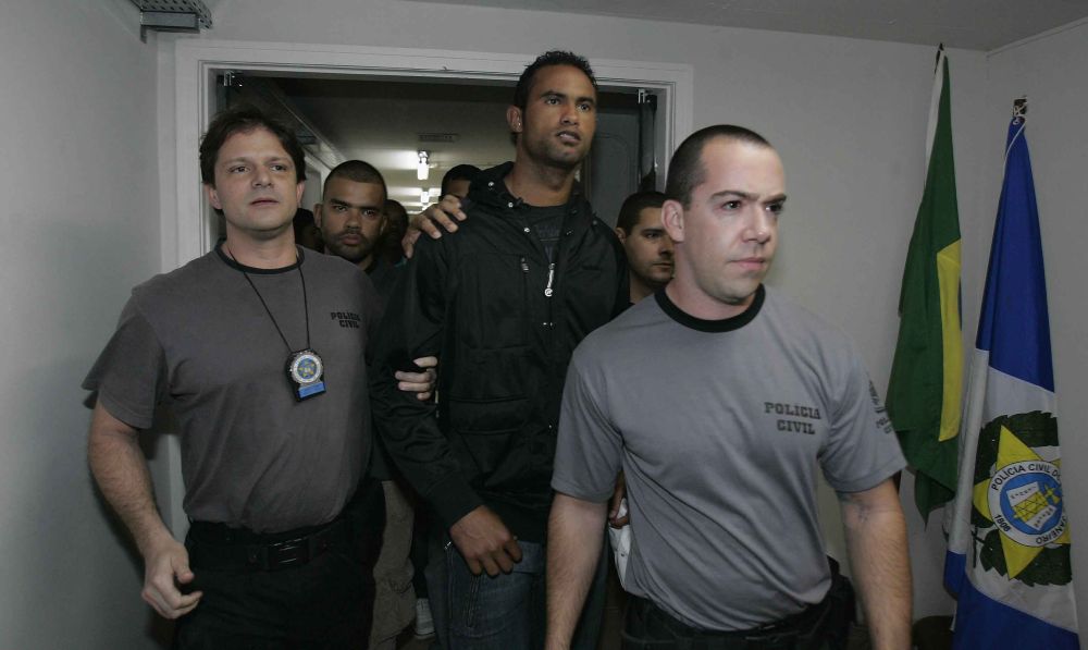 Goleiro Bruno, do Flamengo (ao centro), se apresenta à polícia do Rio após ter a prisão temporária decretada: advogado de defesa diz que não há comprovação do envolvimento do jogador com o crime | André Mourão / Agência O Dia