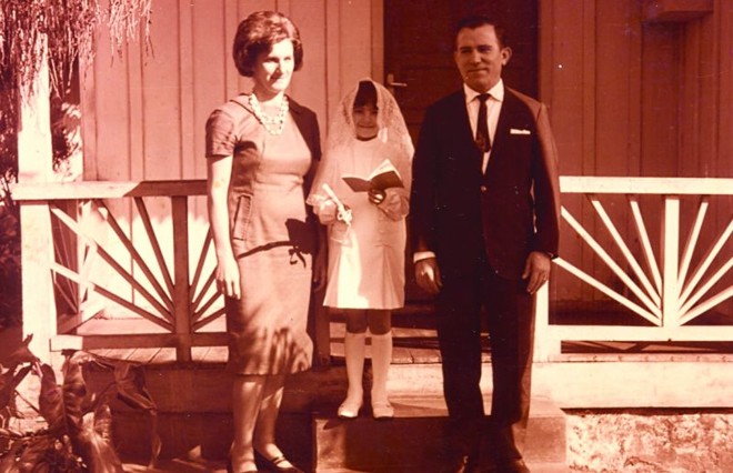 A ministra Marcia Lopes, em foto do dia de sua primeira comunhão, com os pais: família religiosa |