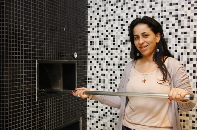 Na residência de Carla Fonseca, os arquitetos Flávia Caldeira e André Bertoluci projetaram um forno de pizza a lenha seguindo os mesmos padrões da churrasqueira | 