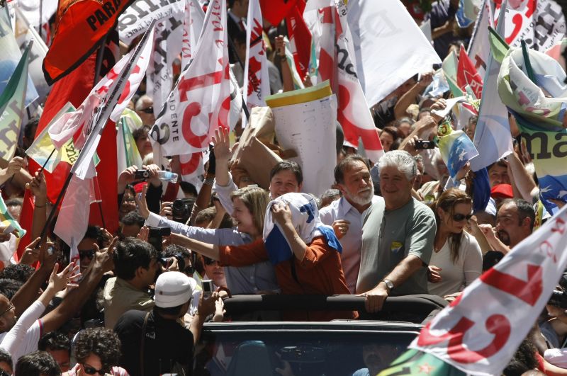 Dilma Rousseff na Rua XV ao lado de Gleise Hoffmann, Osmar Dias e Roberto Requião: candidata do PT usou camiseta para proteger a cabeça das bexigas com água | Jonathan Campos / Gazeta do Povo