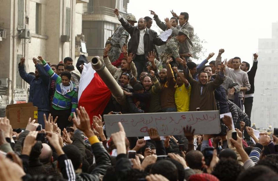 Manifestantes celebram em cima de um tanque do exército na praça Tahrir, no Cairo, durante protesto neste sábado | Yannis Behrakis/Reuters