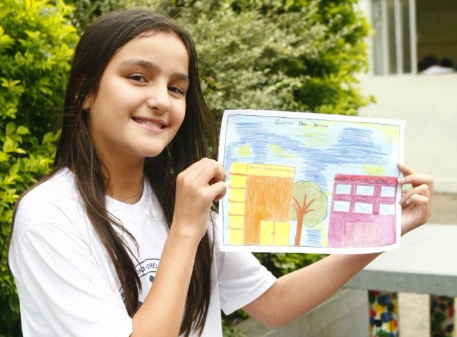 Mariana de Oliveira, 11 anos, do Colégio Padre Cláudio Morelli, desenhou uma escola para alunos com necessidades especiais e um prédio da Polícia Civil porque está tendo muitas coisas ruins | 