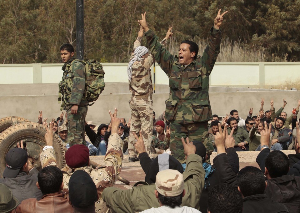 Civis que se juntaram ao exército rebelde gritam palavras de ordem contra o governo de Kadafi em Benghazi | REUTERS/Suhaib Salem