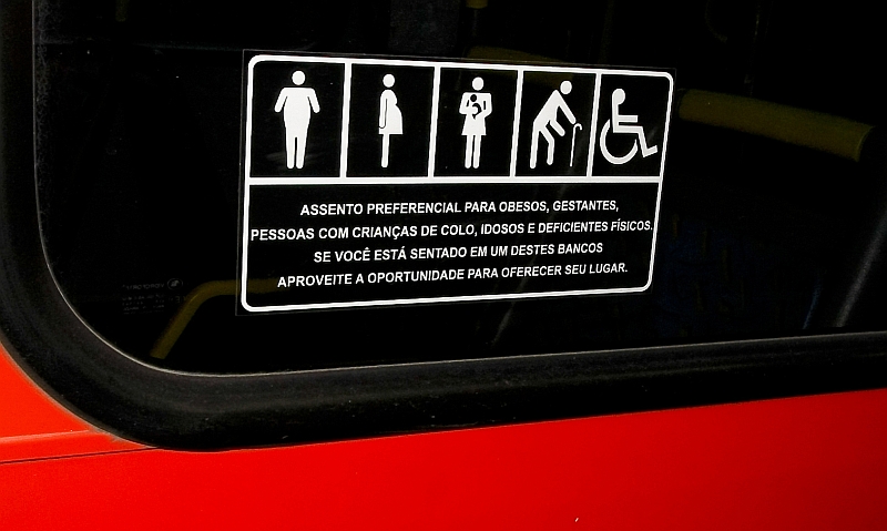 Apesar do alerta, alguns passageiros ignoram adesivo que indica bancos preferenciais nos ônibus | Antônio Costa/ Gazeta do Povo