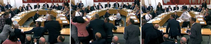 Um homem da plateia tentou atingir Murdoch com uma espécie de torta feita de espuma | AFP PHOTO/PARBUL