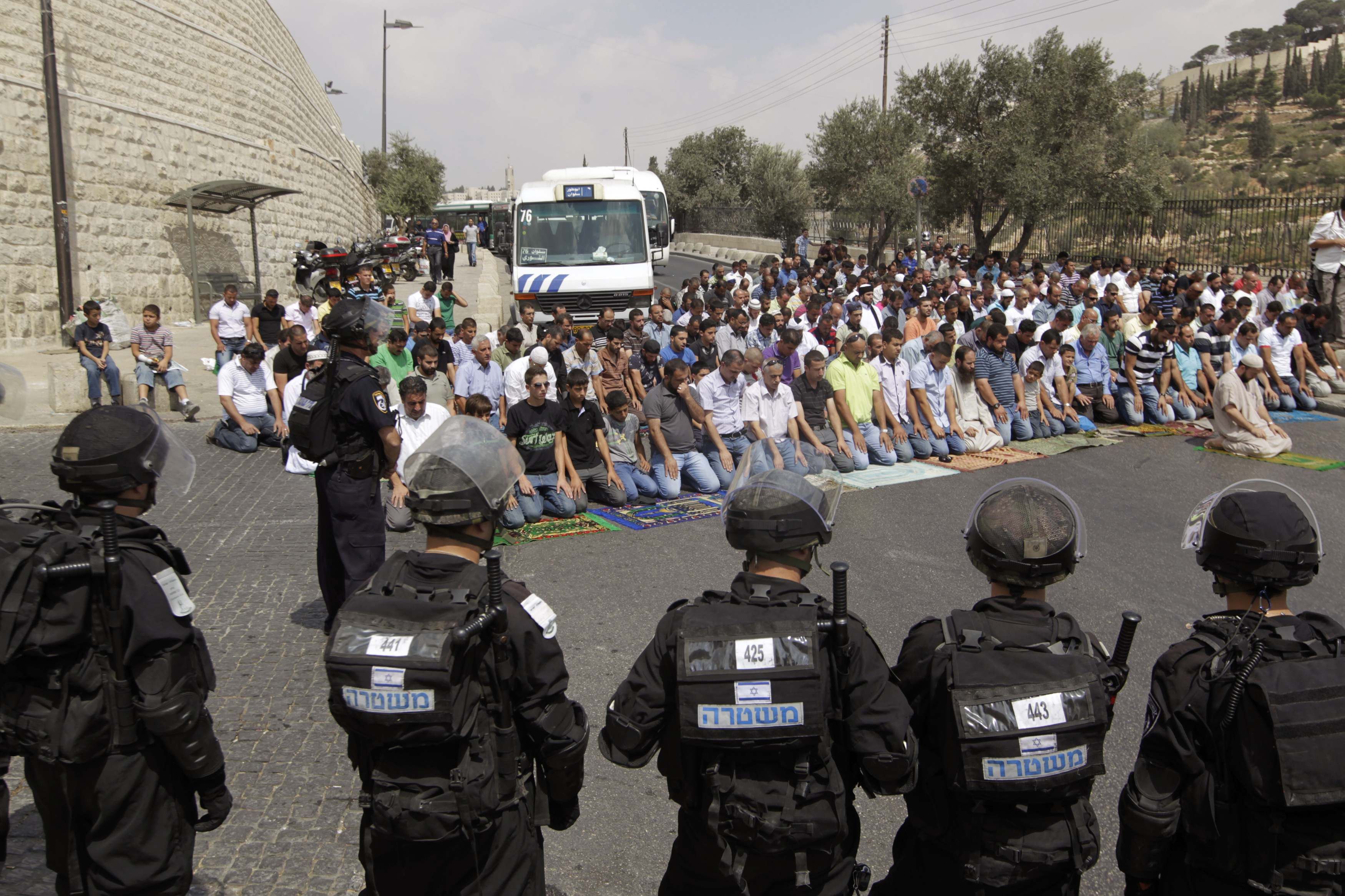 Palestinos rezam enquanto polícia israelense se posiciona em Jerusalém | REUTERS/Ammar Awad
