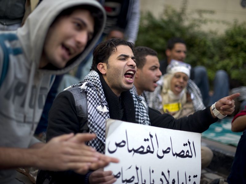 Manifestantes egípcios gritam slogans em frente da casa do premiê Kamal Ganzouri, nomeado pela junta militar: escolha não agradou | Odd Andersen/AFP