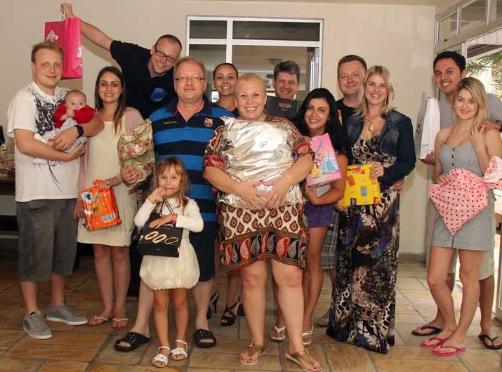Taíbio Franzin (de camisa listrada, azul e preta), sua mulher Tânia (ao centro, com o pacote de presente dourado) e toda a família reunida para o Natal na praia | Walter Alves/ Agência de Notícias Gazeta do Povo