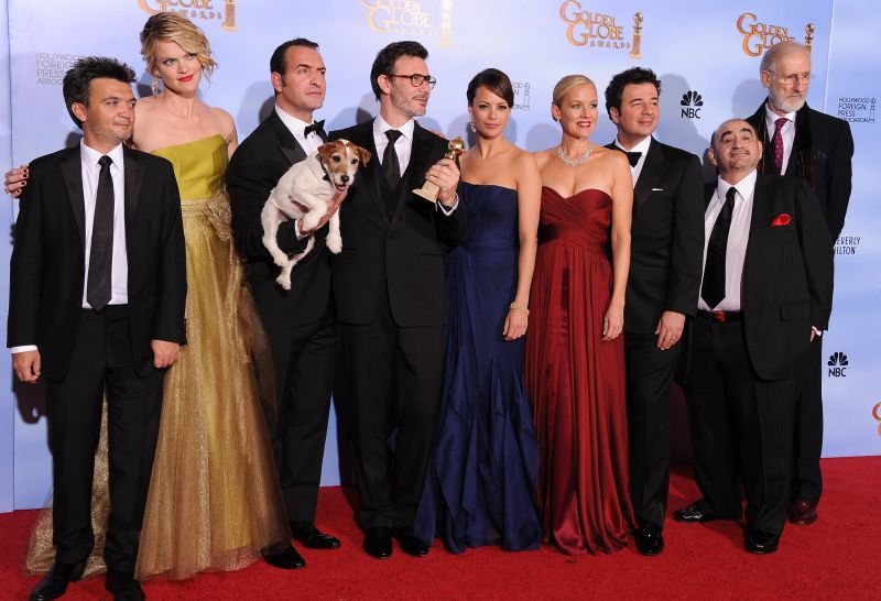 Elenco e equipe de O Artista com o cão-ator Uggie: filme mudo recebeu três troféus | Robyn Beck/AFP