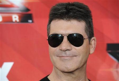 Simon Cowell posa para fotos após entrevista coletiva do programa de TV "The X Factor" em Los Angeles | Reuters