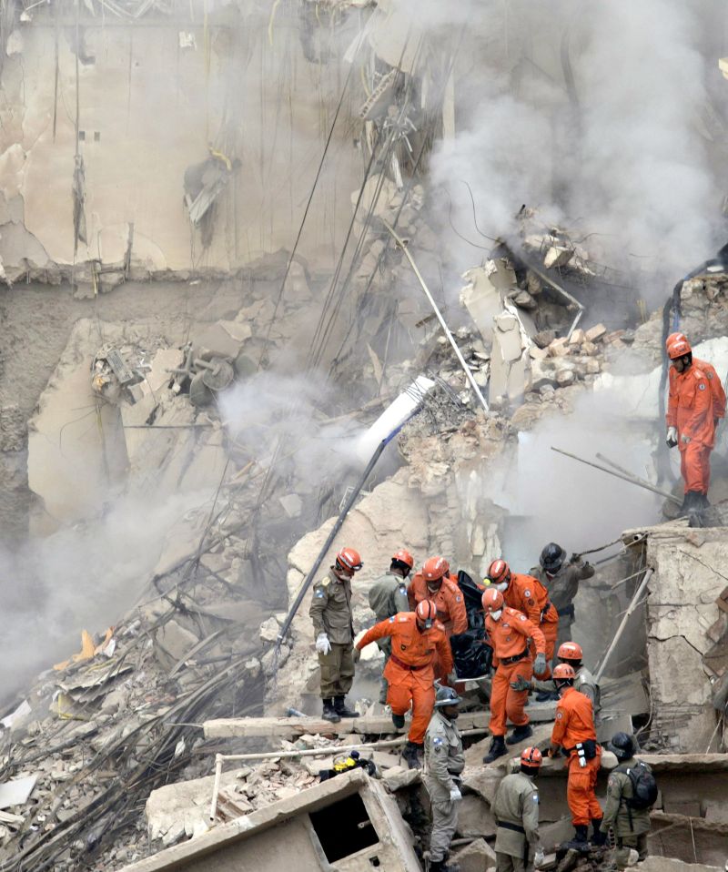 Bombeiros retiram o corpo de uma das quatro vítimas confirmadas até agora na queda do Edifício Liberdade: cães farejadores ajudam nos trabalhos de busca | Ricardo Moraes /Reuters