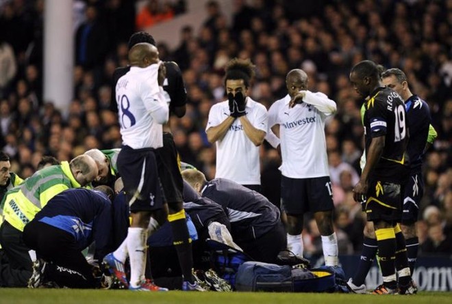 Jogadores do Tottenham (de branco) e Bolton (de preto) preocupados com o meia Muamba |