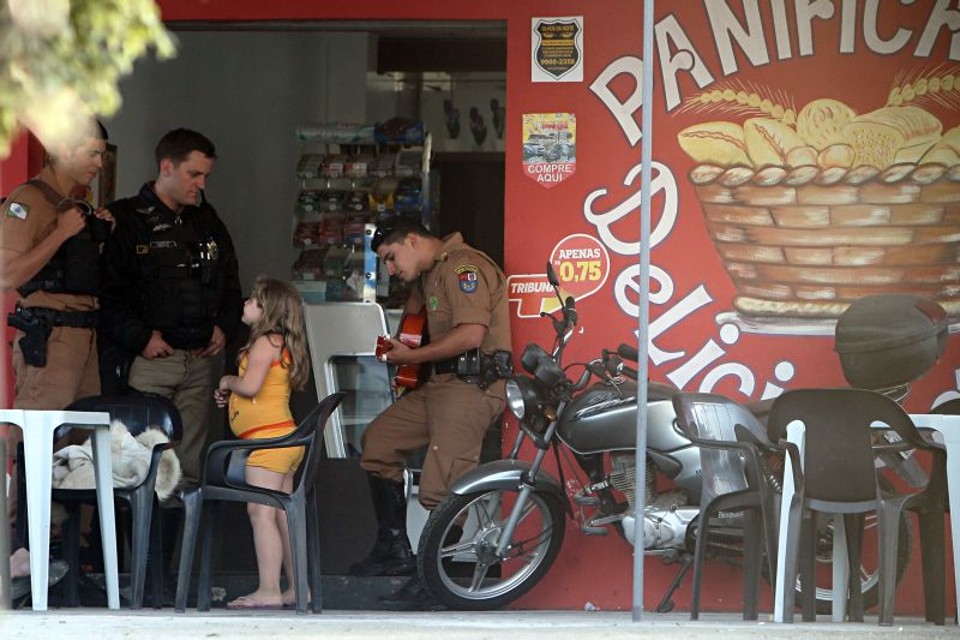 Policial toca violão em comércio do Uberaba de Baixo: aproximação com a comunidade | Albari Rosa/Gazeta do Povo