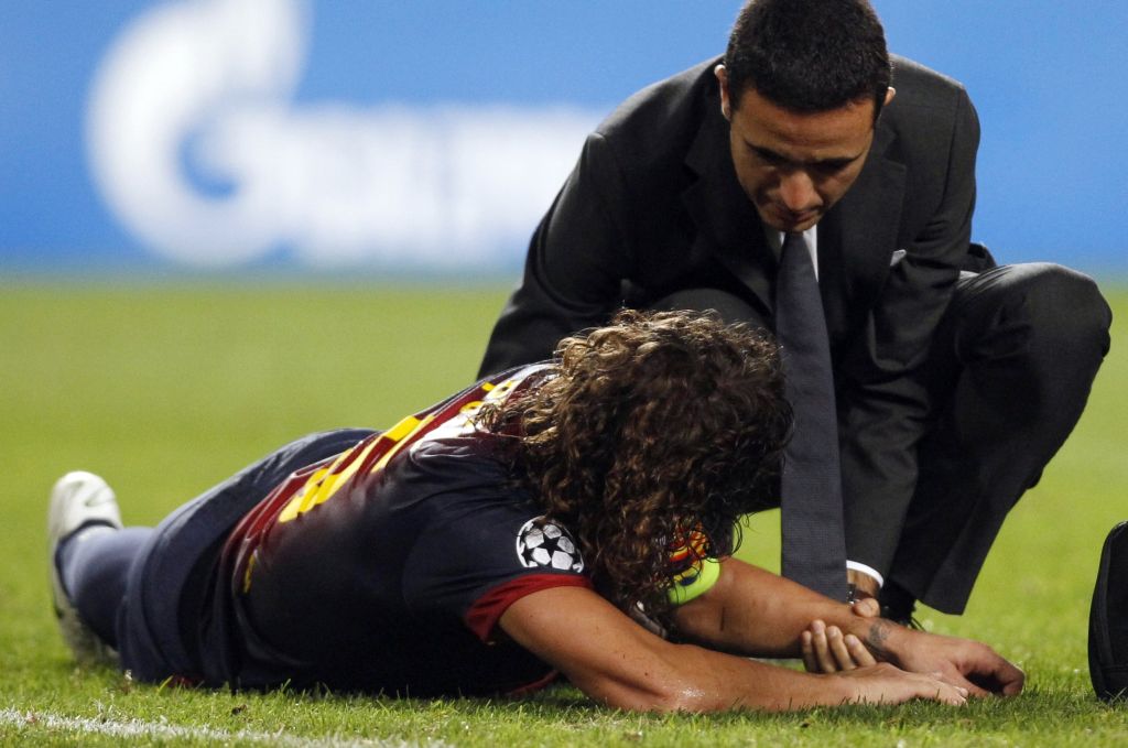 Puyol é atendido em campo no jogo contra o Benfica | Reuters