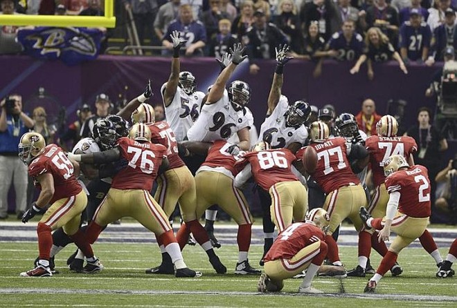 Jogadores do 49ers e do Ravens disputam a bola no Super Bowl |