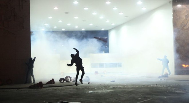 Manifestantes no Palácio Iguaçu em meio à fumaça das bombas lançadas pelos policiais | Daniel Castellano/Gazeta do Povo