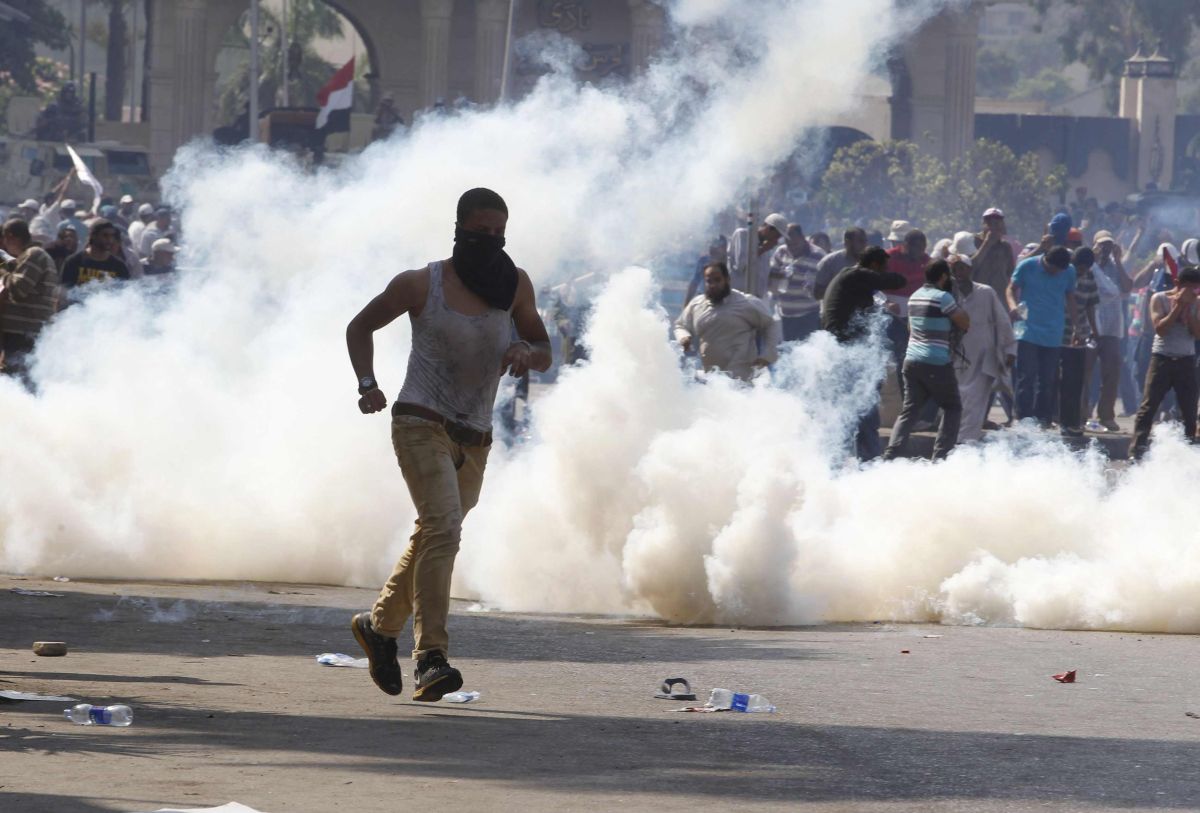 Manifestante pró-Mursi é visto em meio ao gás lacrimogêneo disparado pelas forças de segurança | Reuters/Louafi Larbi