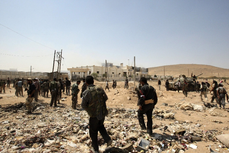 Soldados do Exército Livre da Síria caminham por destroços na cidade síria de Aleppo | Ammar Abdullah/Reuters