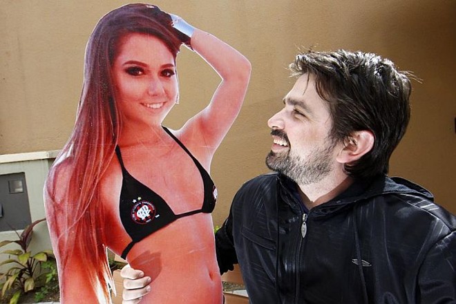 Renato Carpinski com a réplica de Carol Portalupi: cartaz virou febre na torcida atleticana | Albari Rosa / Gazeta do Povo