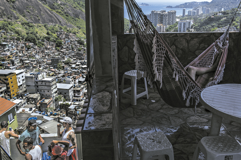 O boom para abrigar turistas para a Copa do Mundo chegou às favelas do Rio de Janeiro. Visitantes estrangeiros; à esquerda, eles desfrutam da visão | Mauricio Lima/The New York Times