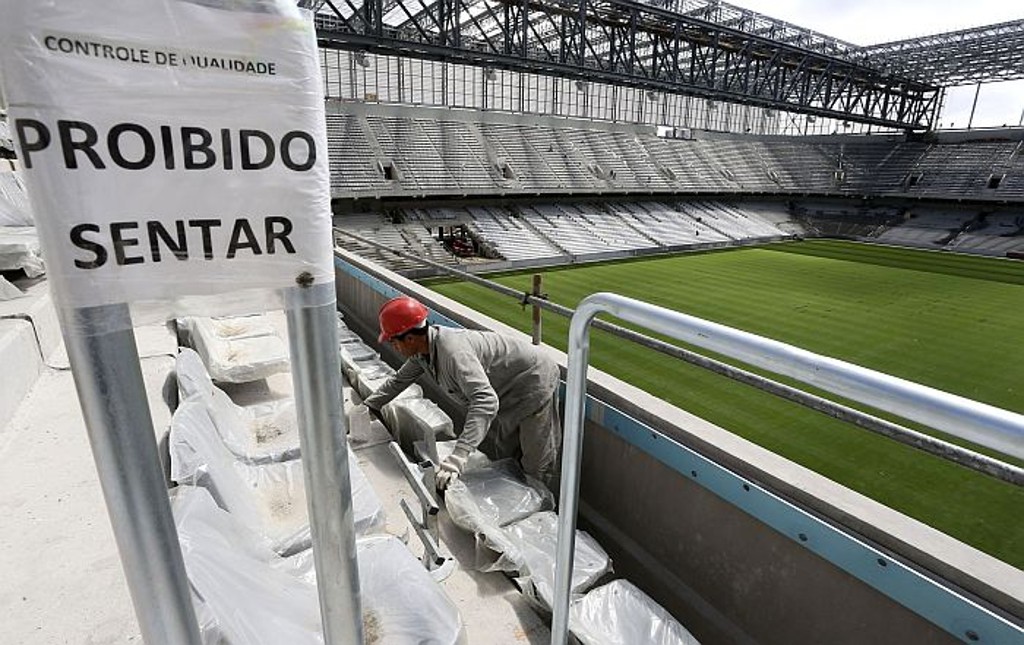 Operários trabalham nas obras da Arena na véspera da decisão da Fifa