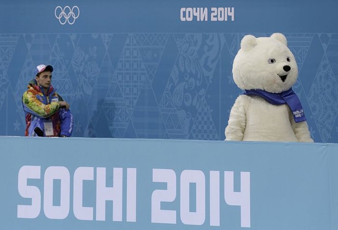 Voluntário observa Urso Polar, um dos três mascotes dos Jogos de Sochi |
