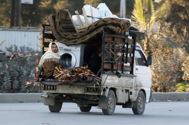 Civis tentam escapar da violência na Síria, carregando pertences em uma caminhonete, na região de Masaken Hanano | Saad Abobrahim/Reuters