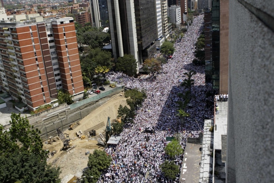 Opositores ao governo de Maduro caminham pelas ruas de Caracas nesta quarta-feira. Segundo o governo, seis morreram | REUTERS/Christian Veron