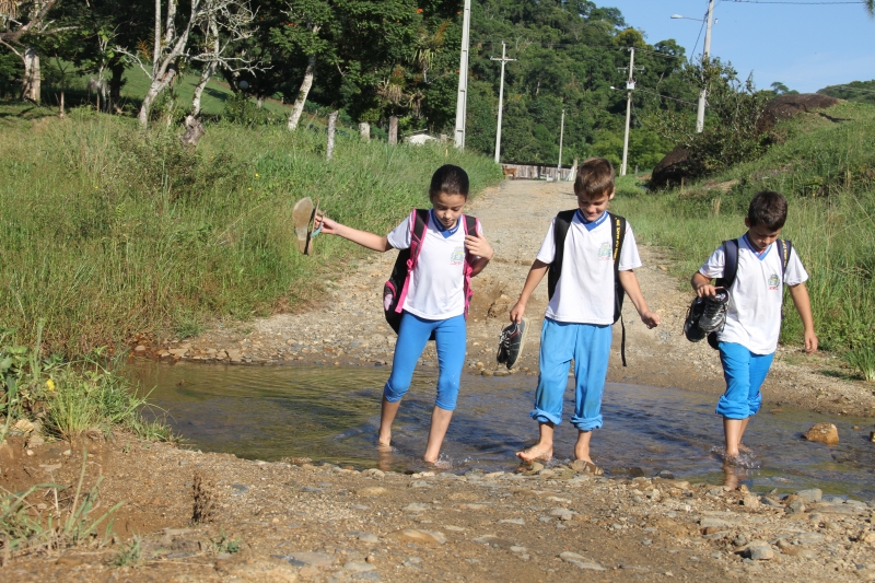 Diariamente, crianças da zona rural de Paranaguá atravessam a pé um córrego que se formou há 500 metros da escola | Oswaldo Eustáquio/ Gazeta do Povo