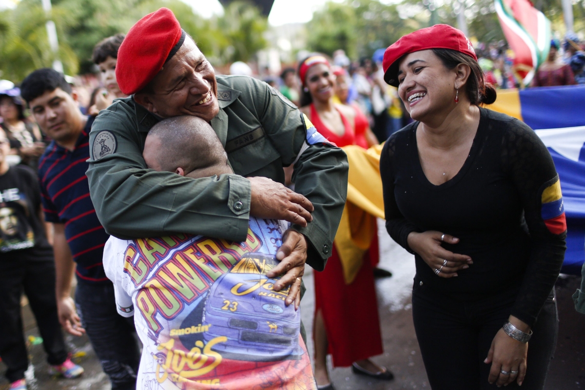 Homem vestido como o ex-presidente Hugo Chávez abraça pessoas durante uma comemoração de carnaval em Caracas, na Venezuela | Reuters/Carlos Garcia Rawlins