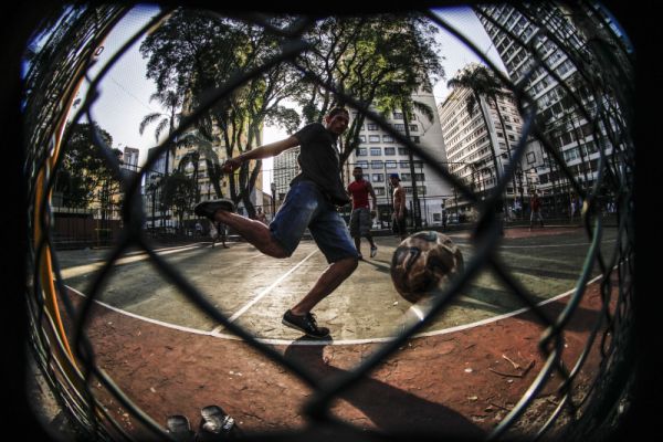 Jovens jogam futebol em quadra pública na Praça Osório, centro de Curitiba | Daniel Castellano / Agencia de Noticias Gazeta do Povo