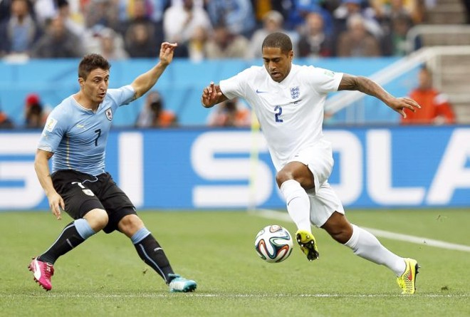 Cristian Rodriguez e Glen Johnson disputam a bola no jogo Uruguai e Inglaterra | 