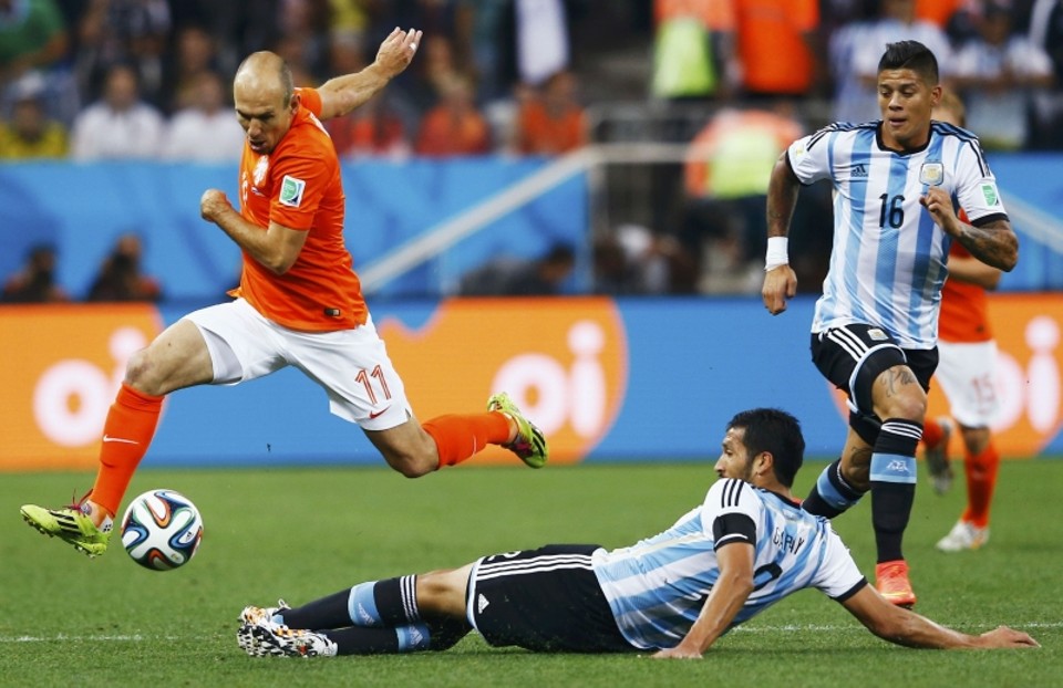 Arjen Robben dribla a bola passando pelos argentinos Ezequiel Garay e Marcos Rojo | REUTERS/Dominic Ebenbichler