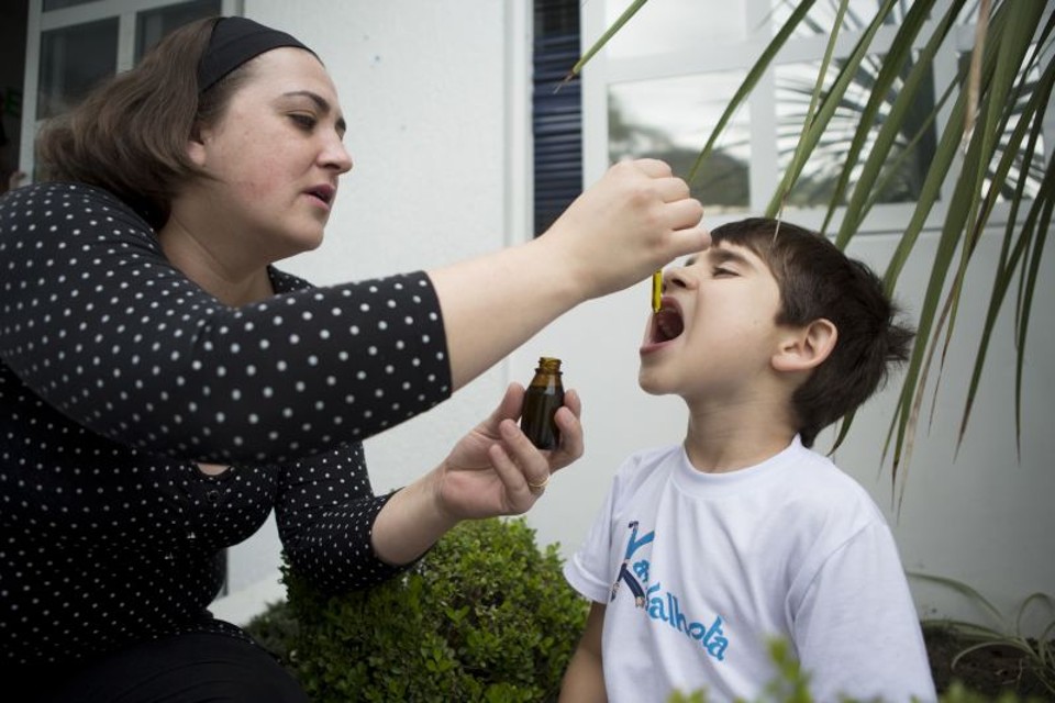 A luta das famílias para usar o canabidiol Priscila Inocente dá canabidiol ao filho, Miguel, de 5 anos. No início deste ano, em meio às dificuldades para importar o remédio, ela mesma produziu a substância em casa | Henry Milléo/Gazeta do Povo